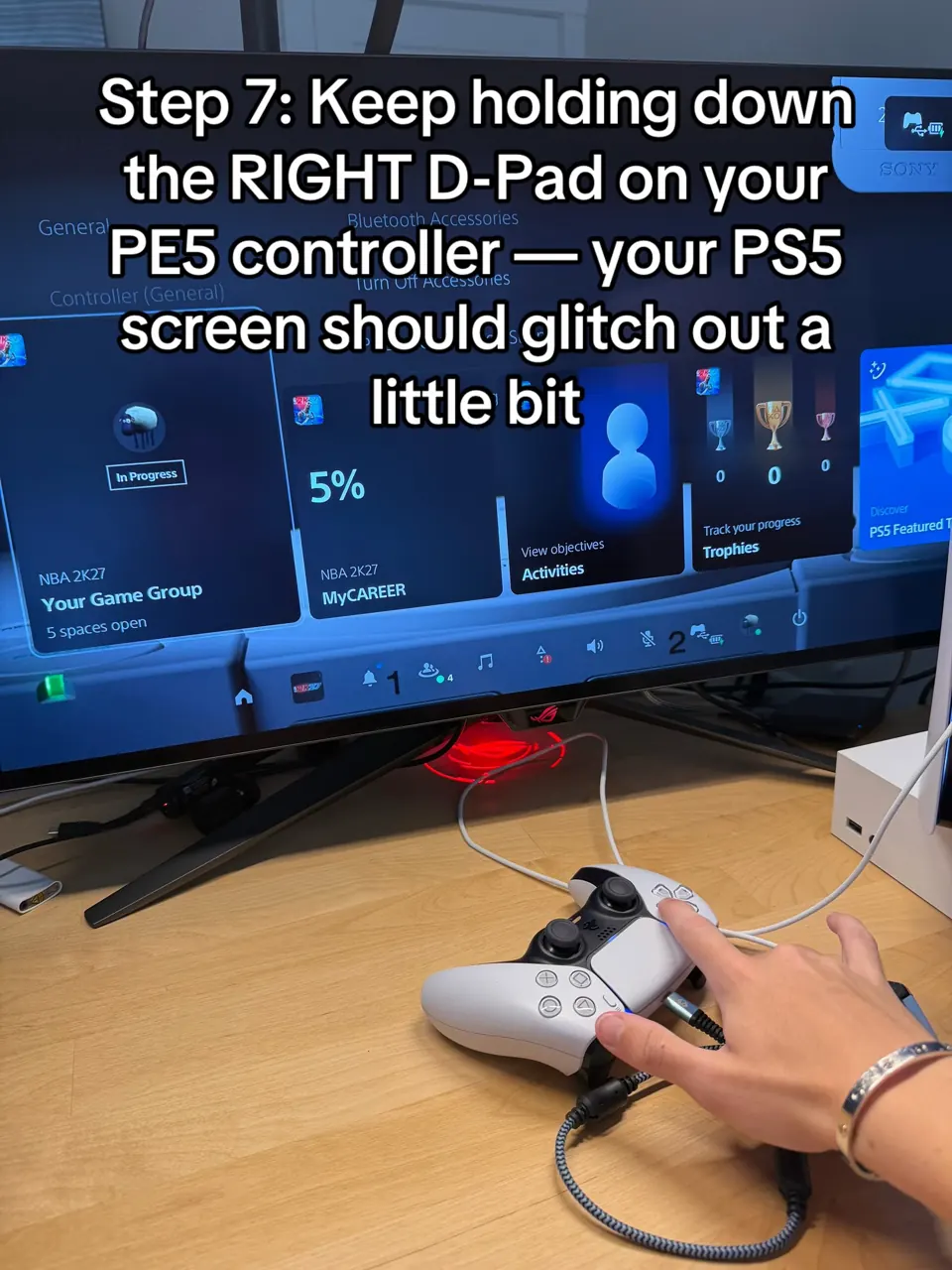 PS5 home screen with tiles shifting while a hand keeps Right held on the controller D-pad