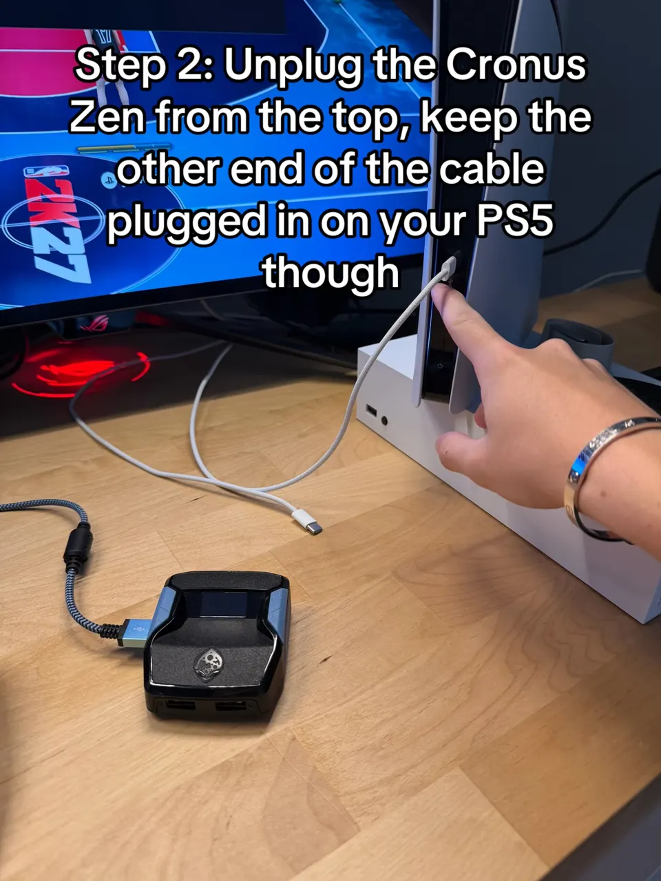 The USB-C cable pulled out of the Cronus Zen's CONSOLE port, other end still in the PS5